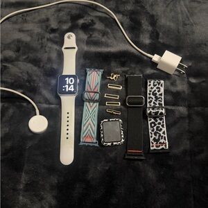 Apple Watch Series 3 with charger, extra bands, face cover, and charms